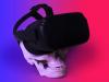 Skull wearing VR goggles on a pink to purple gradient background